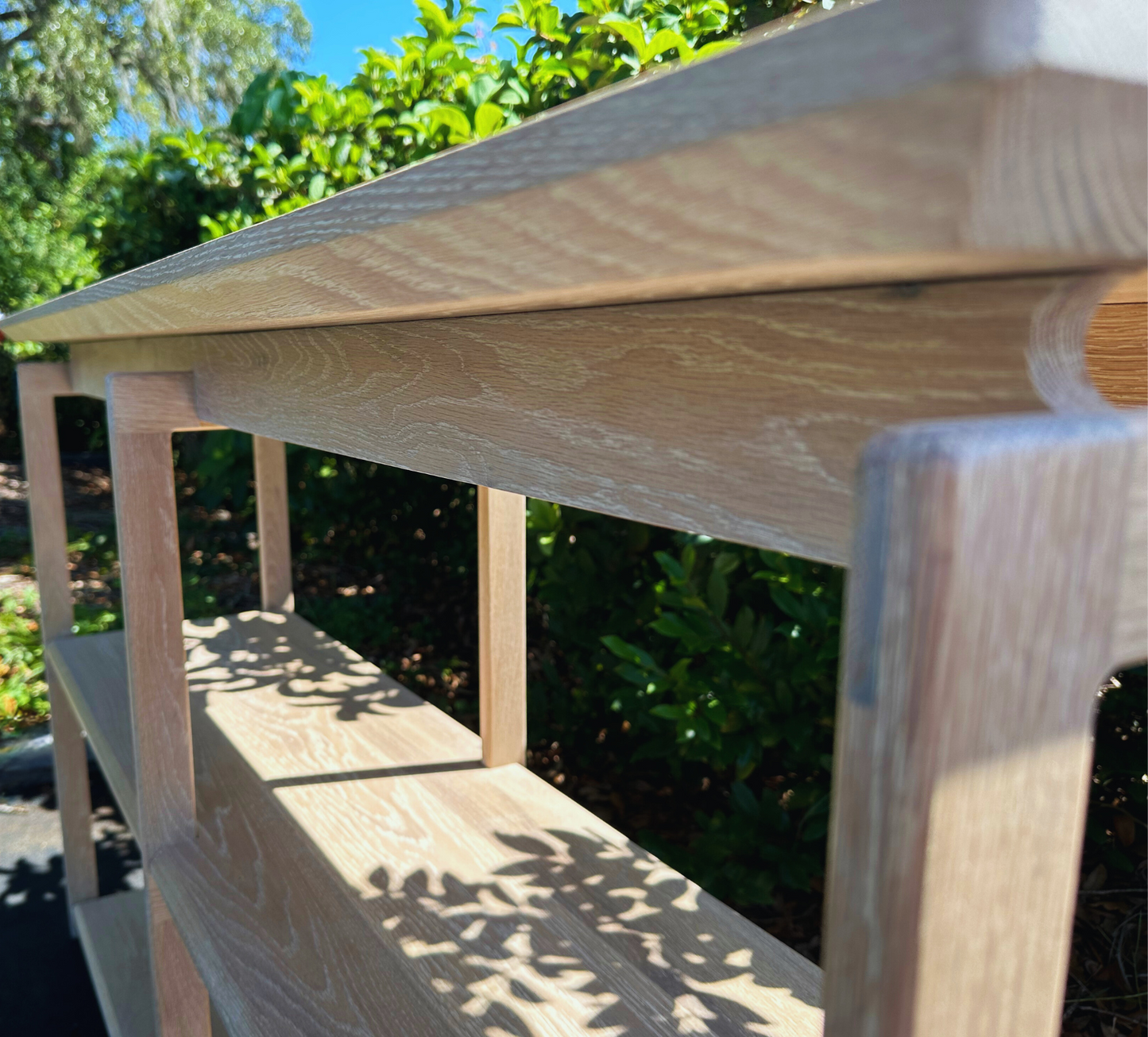 up close corner view of mid-century white oak console .